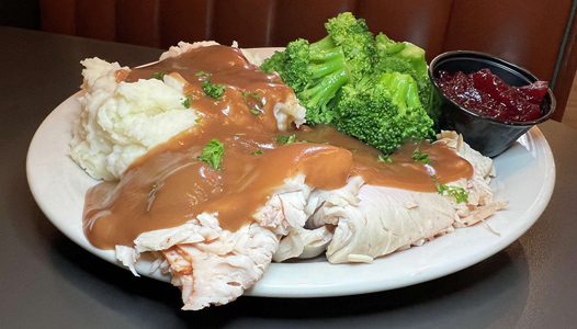 Roasted turkey breast, served with mashed potatoes, cranberry sauce, gravy & our daily vegetable.