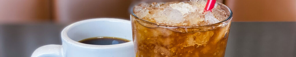A mug of coffee and a glass of iced tea side by side